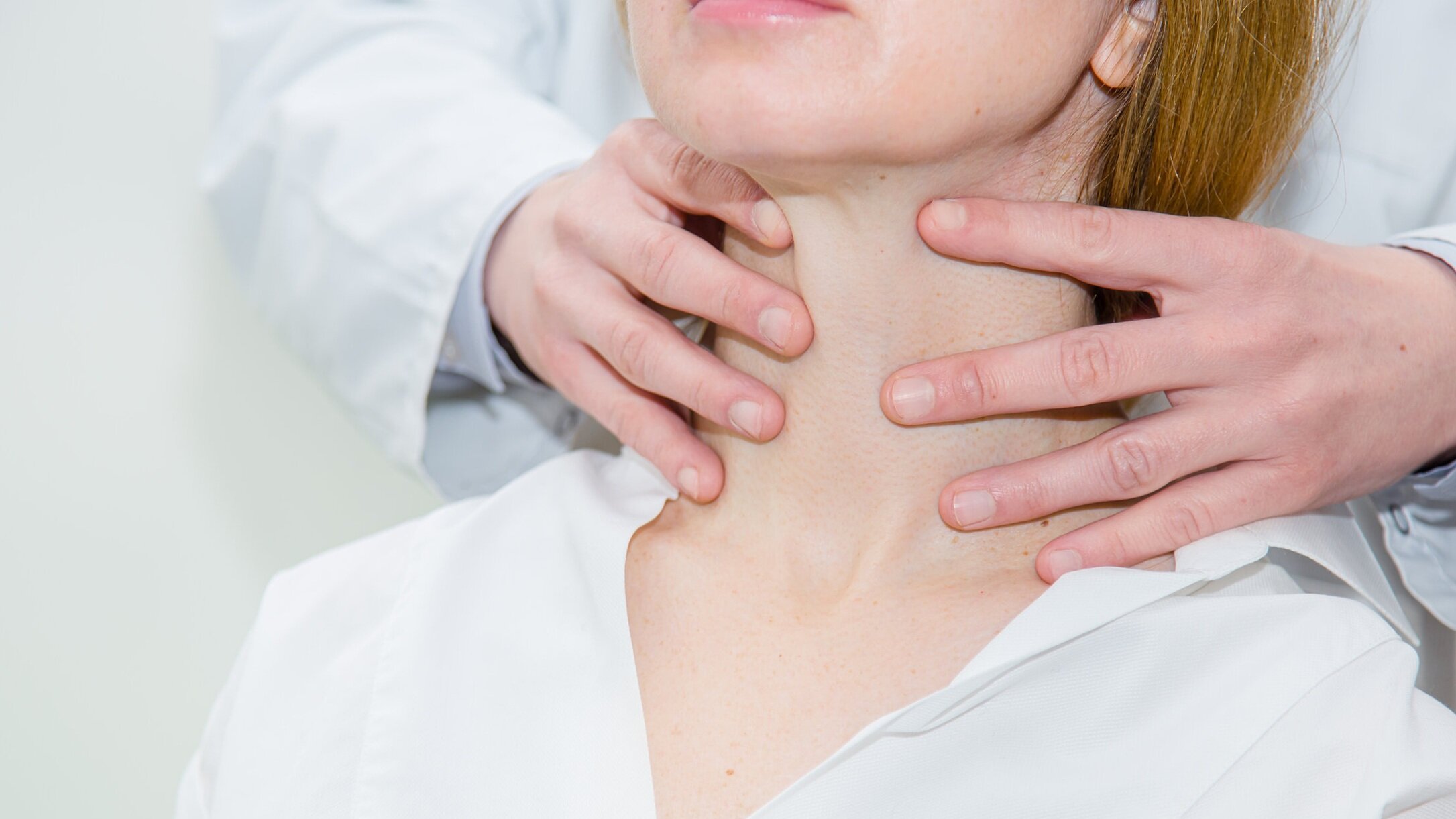 Thyroid neck press doctor checking size of thyroid